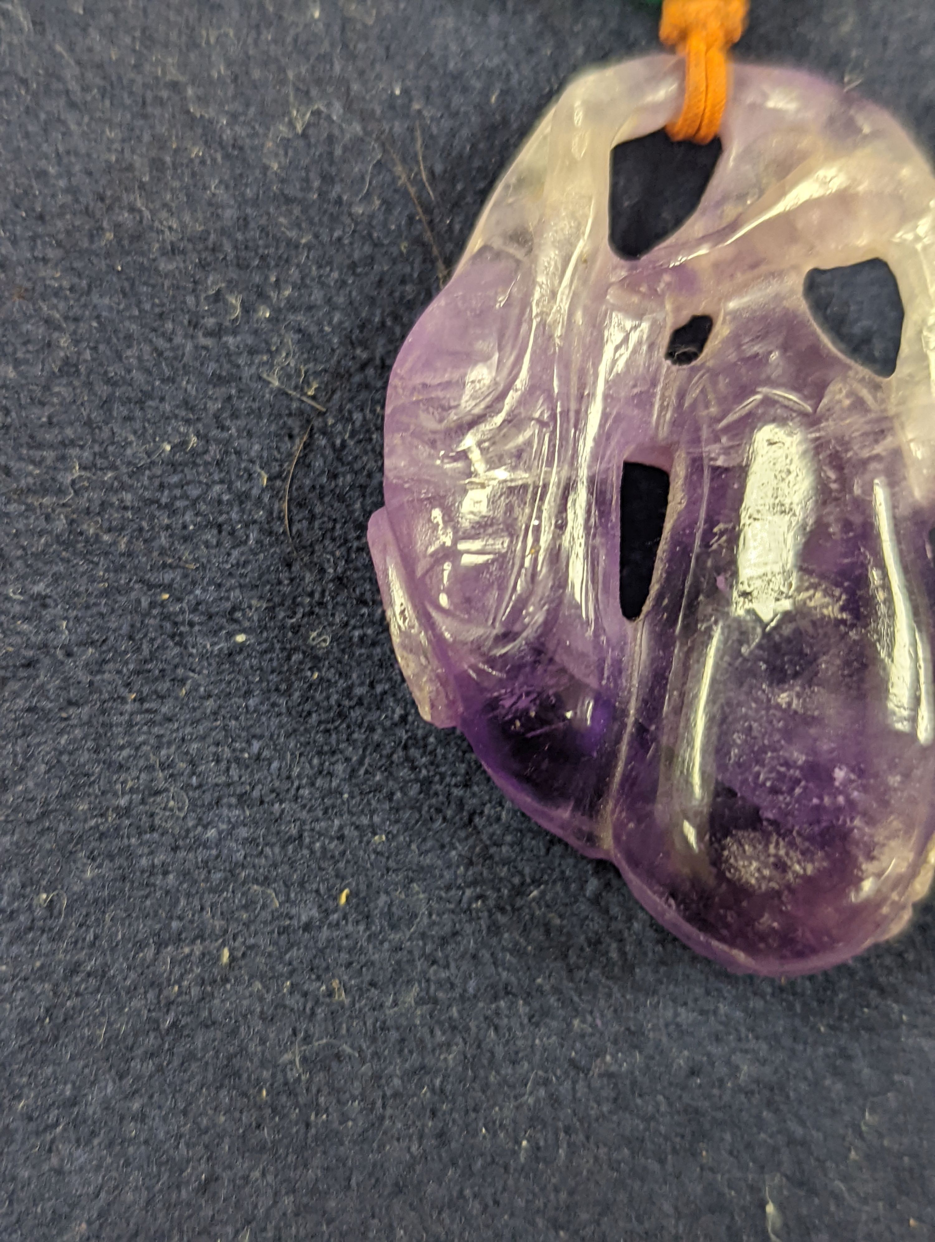 A 19th century Chinese carved amethyst pendant, 5cm on an ornate cord